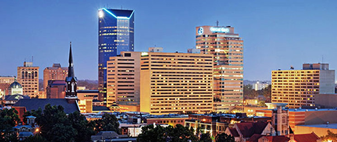 A city skyline at dusk with tall buildings